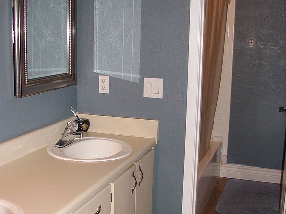 Master bath with double sinks and walk in closet to the right