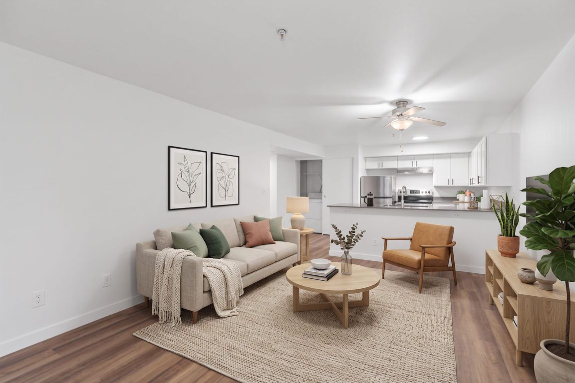 In-unit stacked washer and dryer sit just off the kitchen, so laundry never means leaving your apartment.