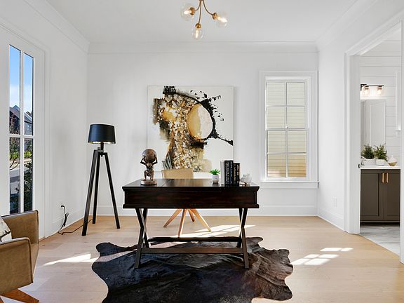 Private office with adjacent full bathroom on main floor.