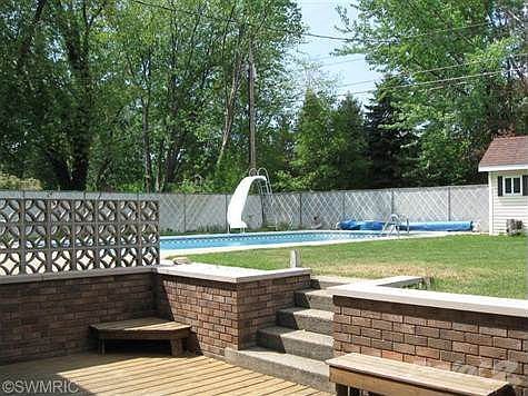 Patio off the lower level rec room. Nice, private back yard, and large lot.