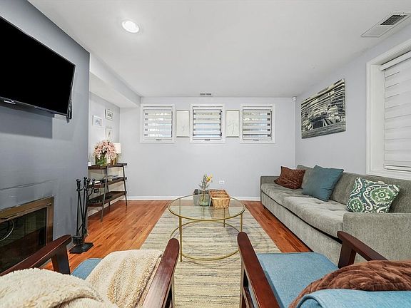 Living Room featuring custom shades & dual working gas & wood fireplace