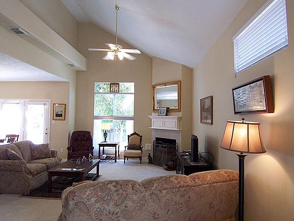 Open living room with vaulted ceiling and window overlooking lake!