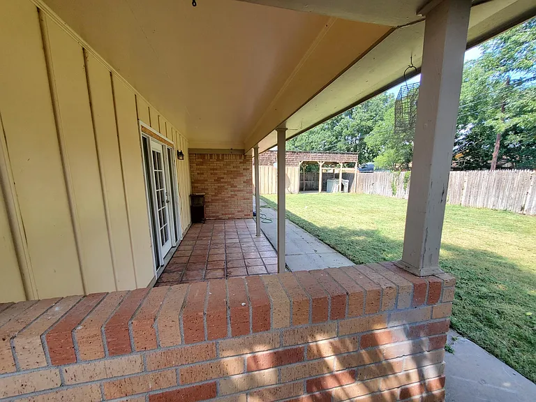 Fenced backyard with patio