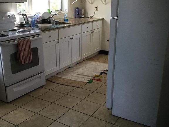 Kitchen granite countertops. electric stove, microwave, refrigerator