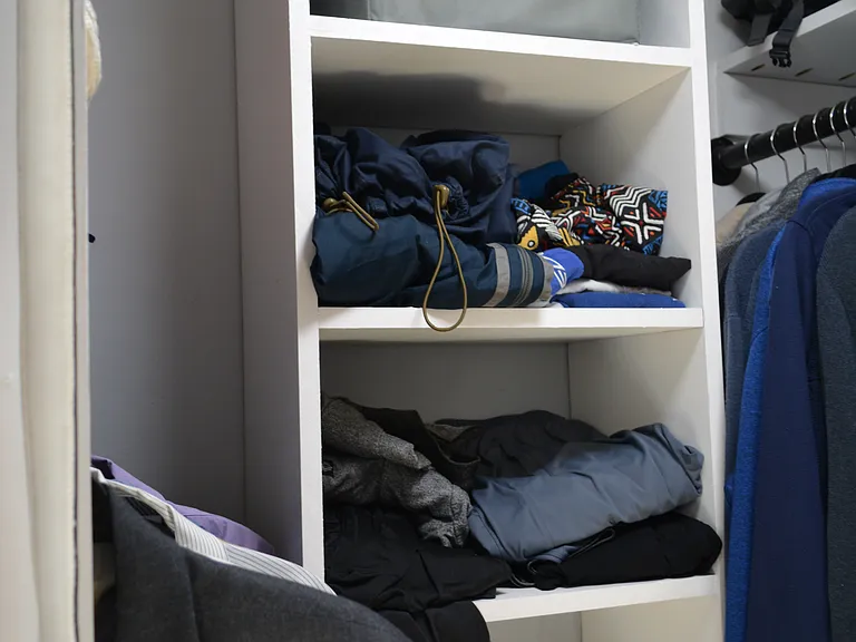 Custom-built storage cubes in the walk-in closet maximize your storage needs