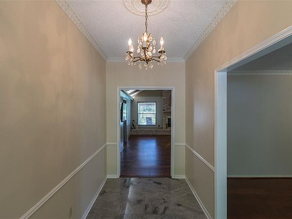 Entry hall with formal living room on the right. Family room straight ahead