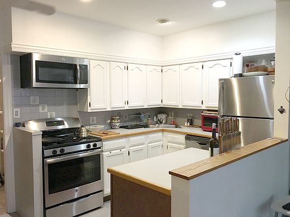Kitchen (as viewed from living room.) Open and bright lighti