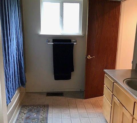 bathroom with full tub and shower