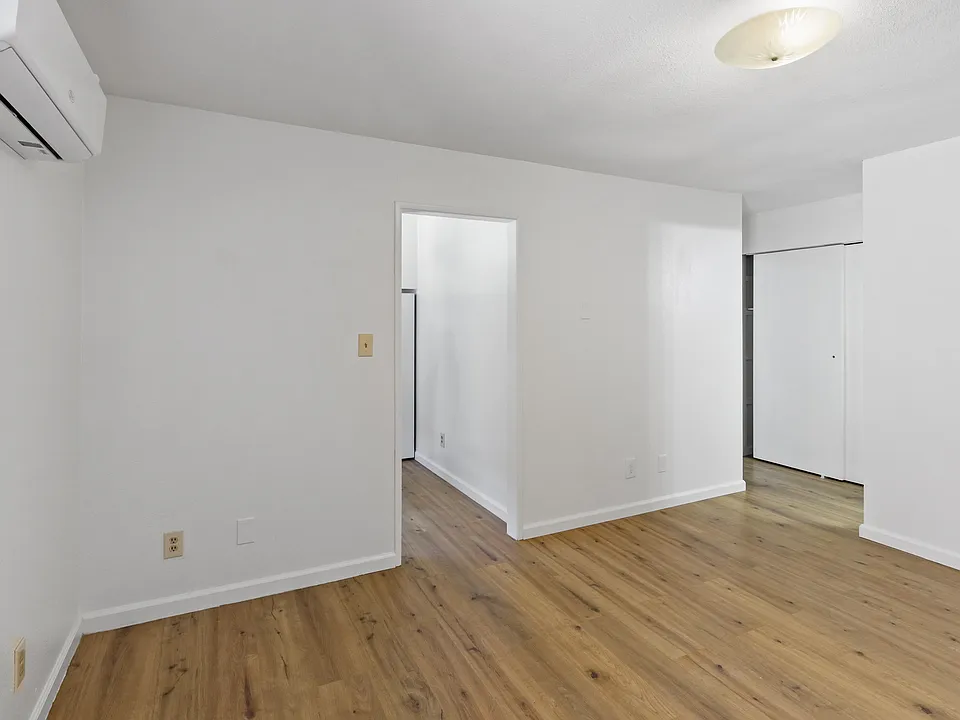 Living Room looking at Front Door/Kitchen Entrance and Bedroom Entrance