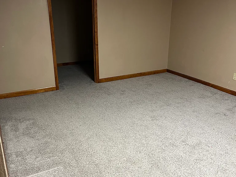 Basement entertainment area with storage room.