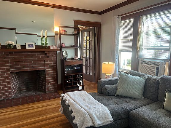 Living room with hardwood floors and fireplace.