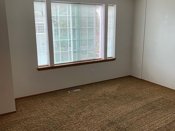 Master bedroom featuring a walk-in closet and private bathroom.