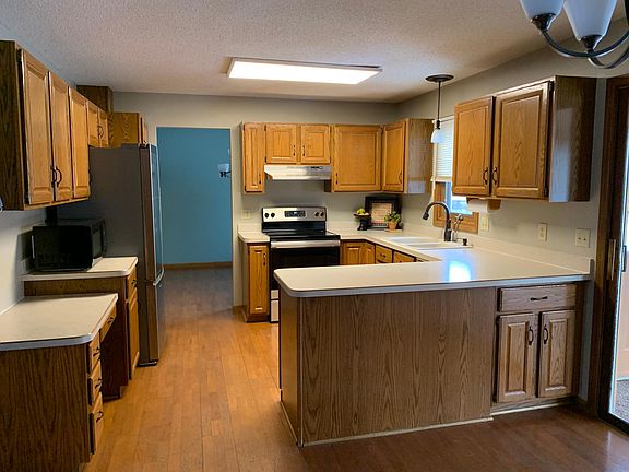 Kitchen with new stainless fridge and oven, dishwasher and microwave. Formal dining room and dinette space on each side of kitchen.