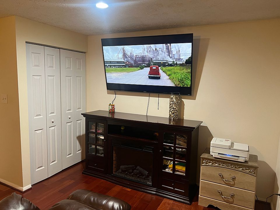 Basement Bedroom #4 with Roku 65" 4k HDTV, Double Recliner Sofa, Treadmill, Queen Bed, Dresser and Mirror