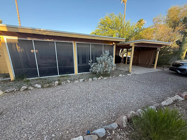 There is an AZ Room on the back of the house that is fully screened, along with a single carport accessed via the alleyway. There is ample parking along the circle driveway as well.