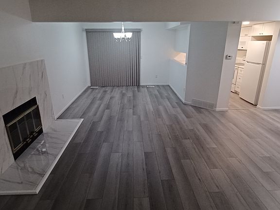 Living Room, Kitchen, Dining Room with Sliding Glass Door leading to Private Balcony