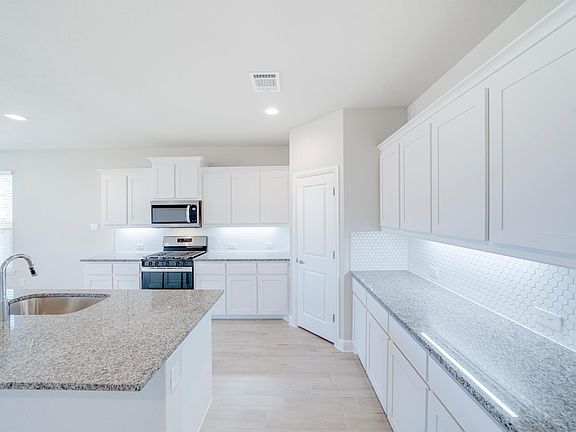 Large eat in-kitchen, dining area and sitting island.