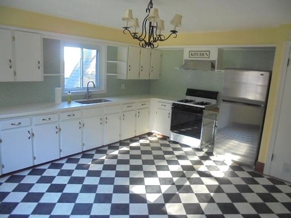 Huge kitchen with tons of cabinets and countertops.