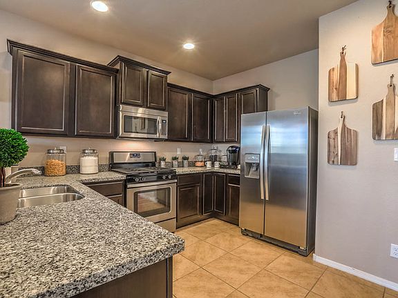Chef-ready kitchen with stainless appliances, granite countertops and espresso cabinets.