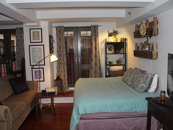 Studio Area as decorated by past residents - with Juliette balconies views of courtyard & water fountain oasis