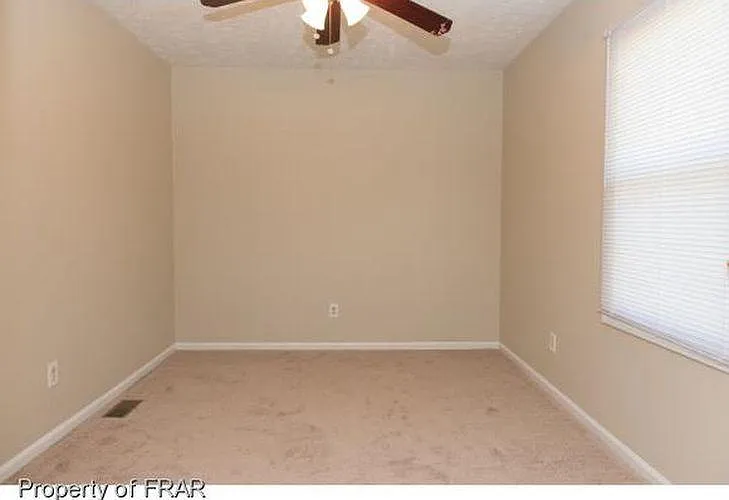 The ceiling fan in the first bedroom is energy efficient. The freshly painted walls, the shampooed carpet, and the new blinds are ready for your move-in date.