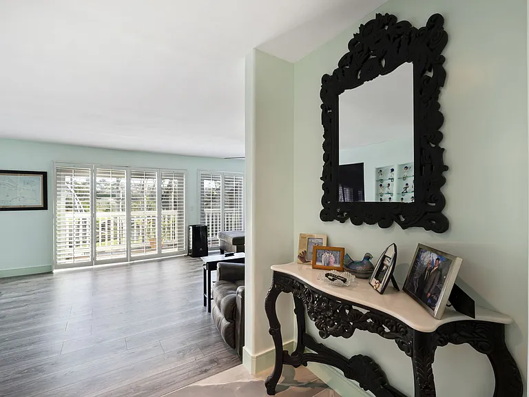 Entryway with combination front door access. The pool key is in the chicken bowl.