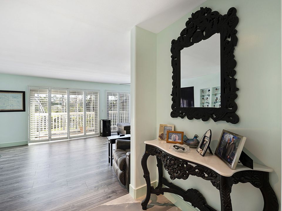 Entryway with combination front door access. The pool key is in the chicken bowl.