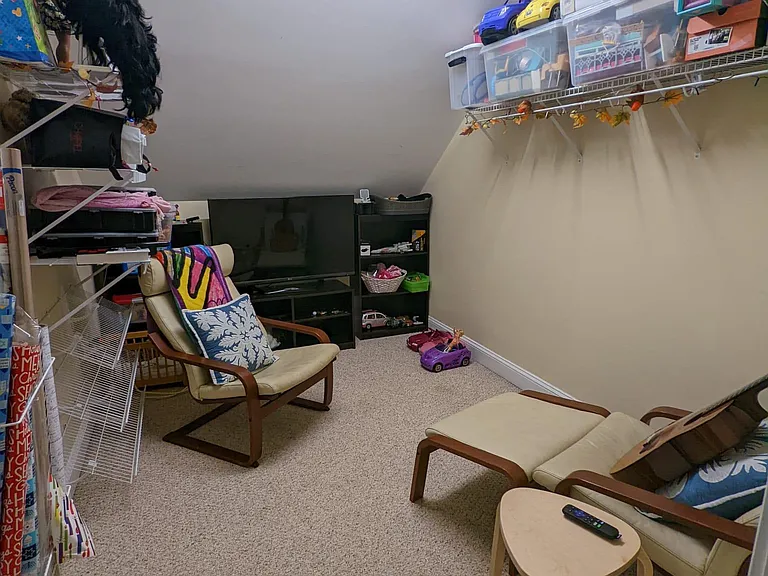 Walk- in closet off the upstairs bonus room. Current occupants use it as a private TV and play room.