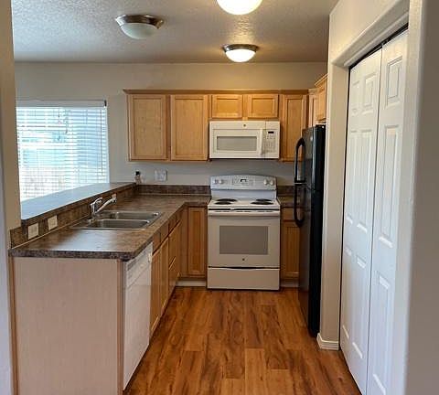 Kitchen with refrigerator, microwave, dishwasher, range and garbage disposal