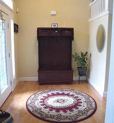 Formal entry with hardwoods leading into family room and kitchen