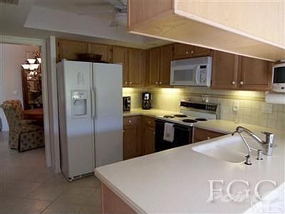 KITCHEN HAS WALL OF CABINETS (LEFT SIDE, NOT VISIBLE IN PHOTO) FOR AMPLE STORAGE.
