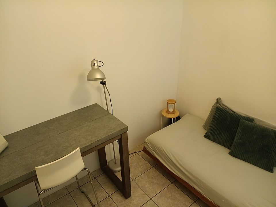 twin bed and big workstation desk with chair