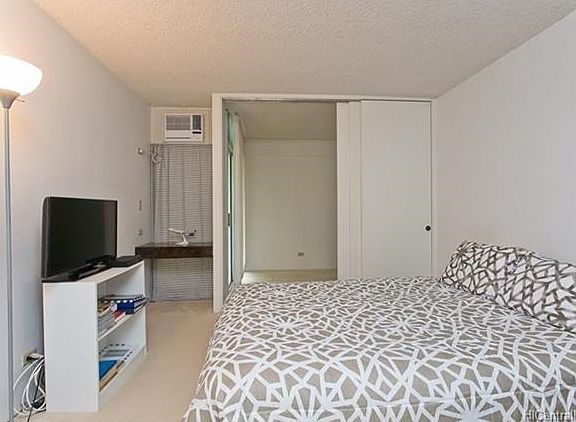 Note small built-in desk niche in corner and access to den from bedroom