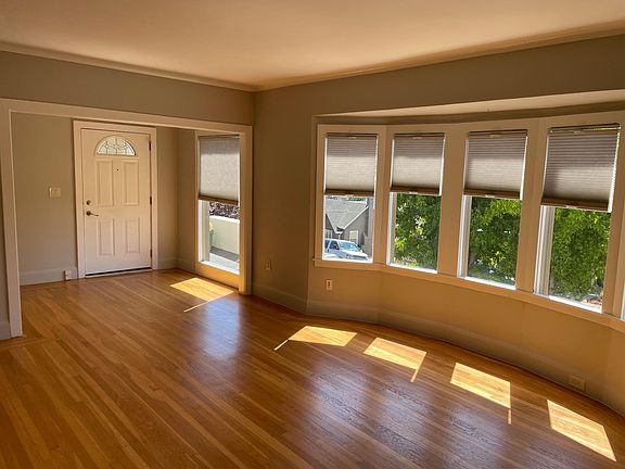 Spacious entry way and living room with bay windows