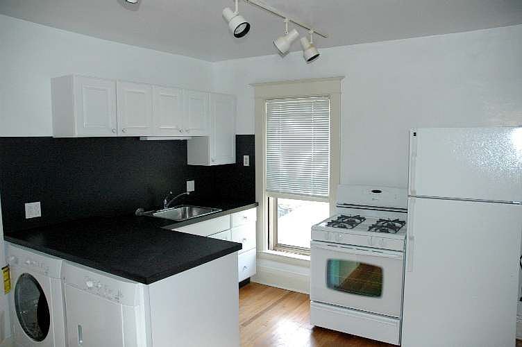 Kitchen with oven, fridge and Washer and Dryer.