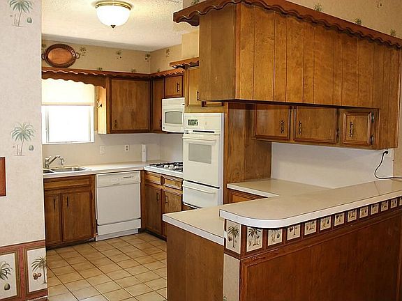 Large kitchen with lots of cabinets and a breakfast bar