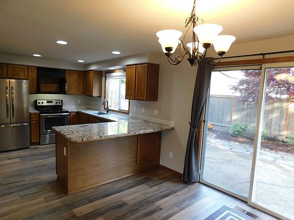 Kitchen peninsula with slider to fenced backyard