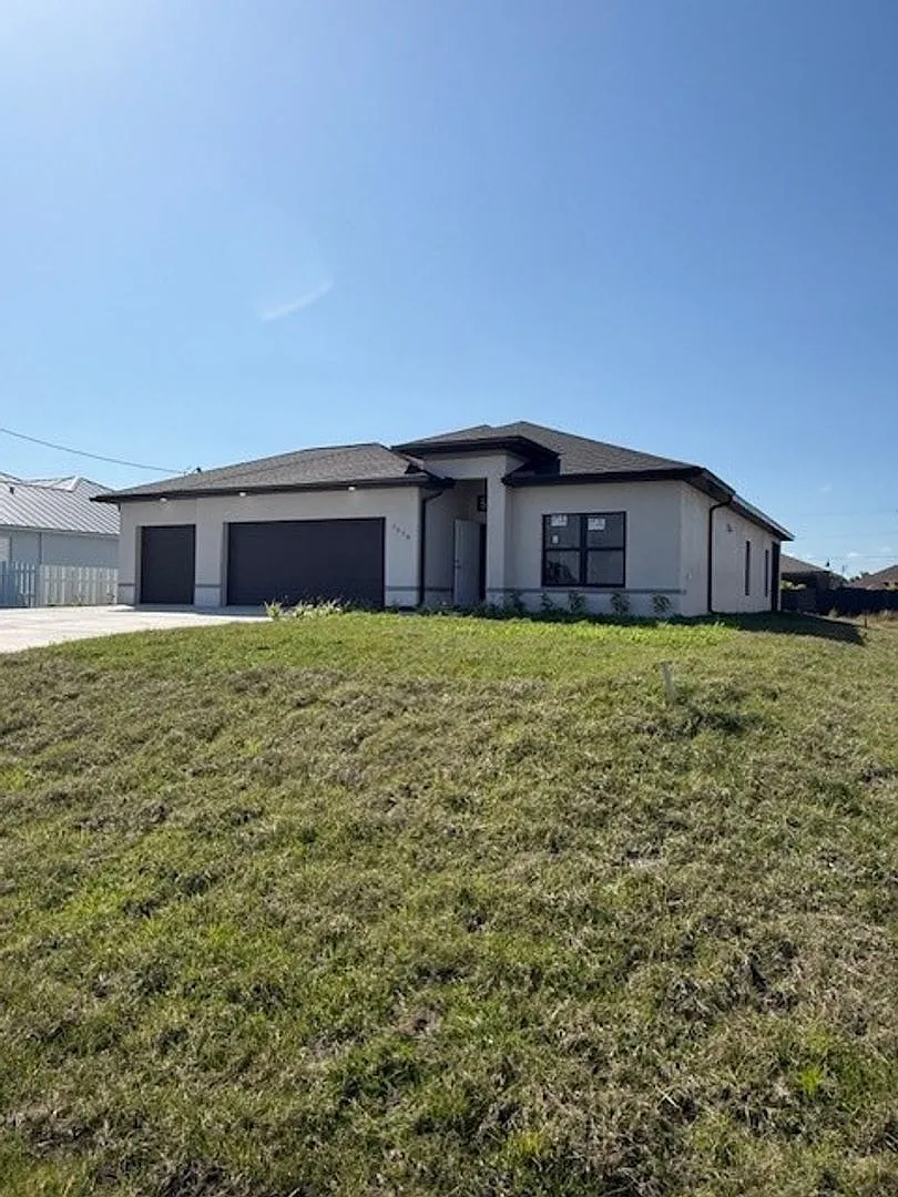 Brand-New Luxury Home with 3-Car Garage & Lawn Care Included | Modern Living in Cape Coral! — Photo 2