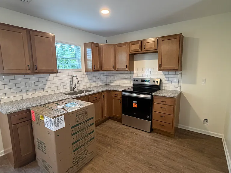 Kitchen with BRAND NEW Whirlpool Stainless Steel Appliance and Granite Countertops
