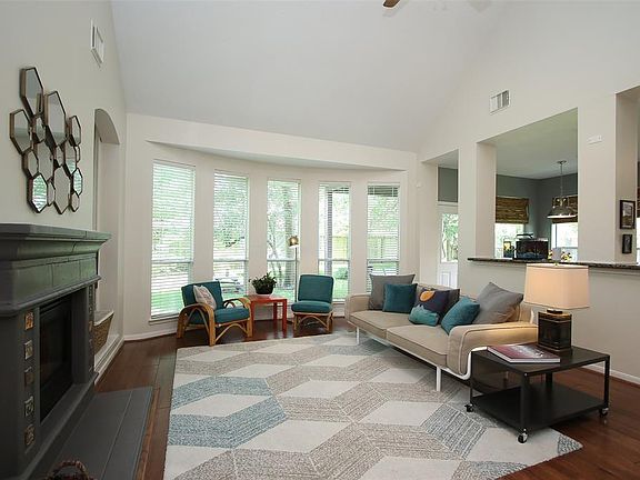 The Rich Hardwood Flooring continues into the Family Room with a Wall of Bayed Windows Overlooking the Serene Wooded Back Yard...
