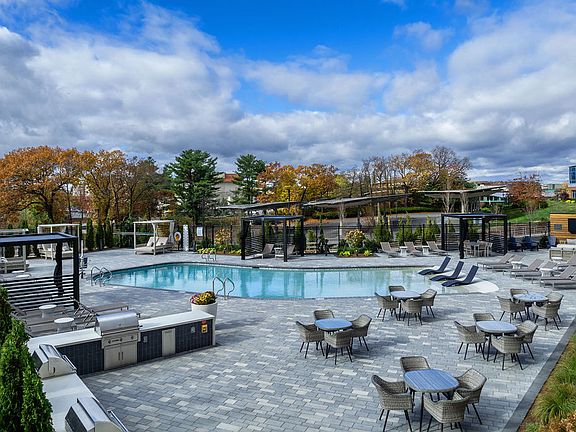 Outdoor walk in pool with ample seating and BBQ Grills for a fun day close to home.