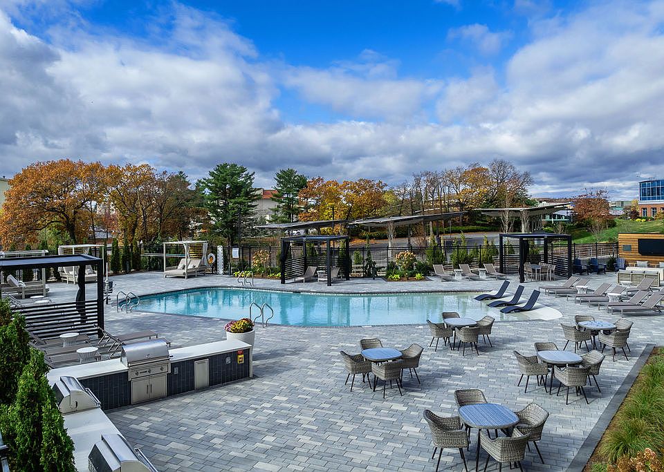 Outdoor walk in pool with ample seating and BBQ Grills for a fun day close to home.