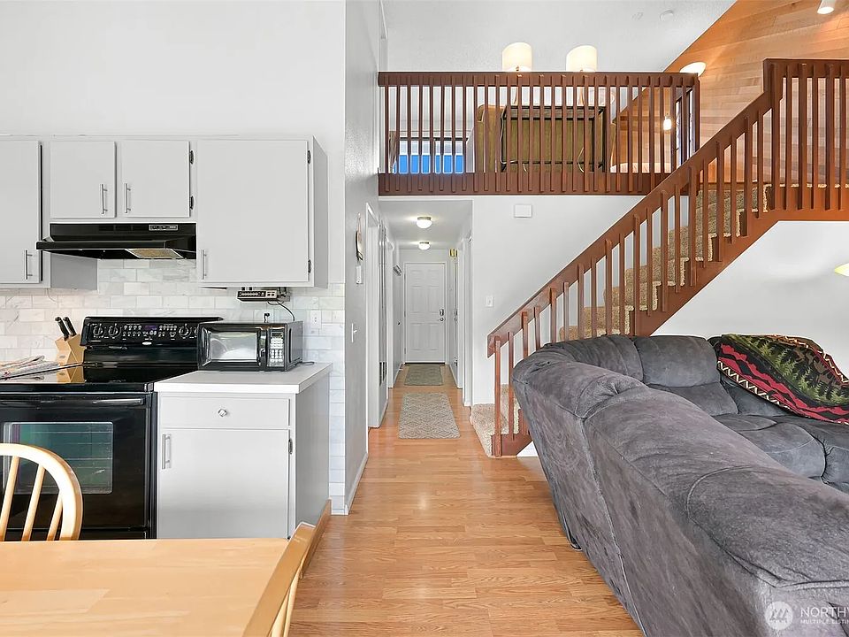 Kitchen to the left, living area to the right, loft up the stairs