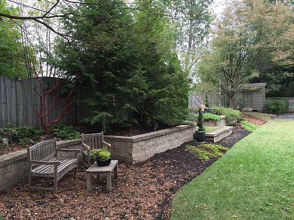 Landscaped back yard
						:
						masonry garden walls, seating areas, mature, low-maintenance plantings.