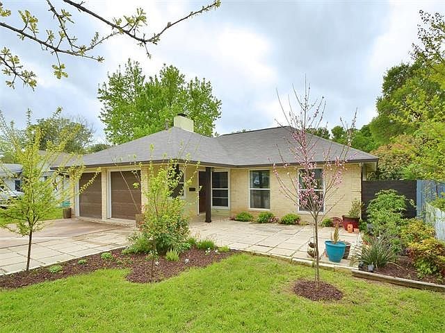 Great curb appeal with lush landscaping and a front patio