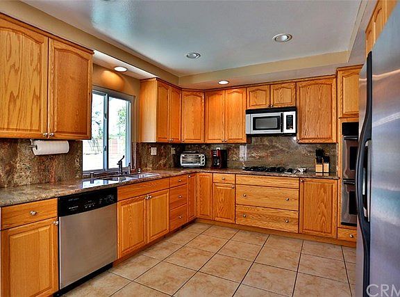 Remodeled kitchen with granite counter top and stainless steel appliances.