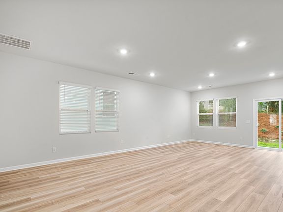 Open space concept. Living room and dining with double door access to patio