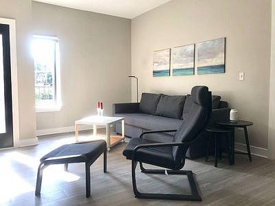 Bright natural light in the family room with access to the balcony.