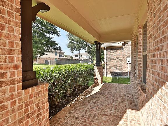 WELCOMING FRONT PORCH: As cooler weather arrives, this front porch can be a favorite spot for to enjoy the outdoors. The brick flooring adds a custom touch to the space.
