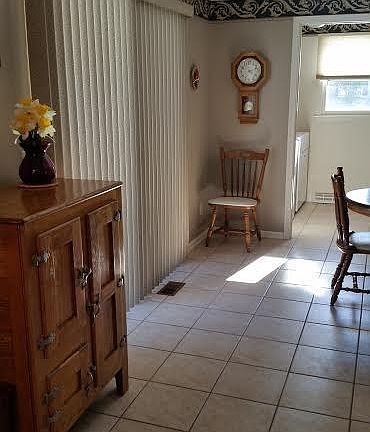 Sliders from the kitchen lead to the back yard